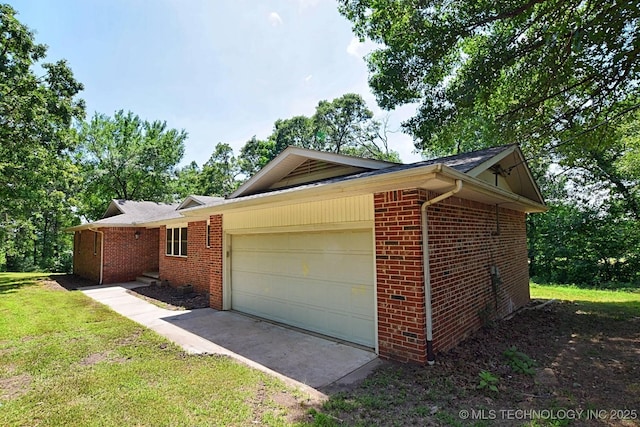 view of side of property with a lawn and a garage