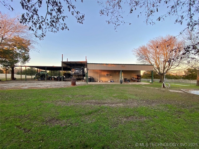 exterior space featuring a lawn and an outdoor structure