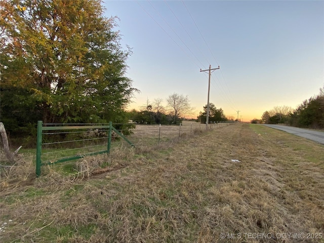 yard at dusk with a rural view