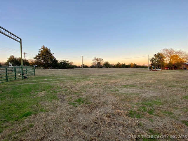 yard at dusk with a rural view