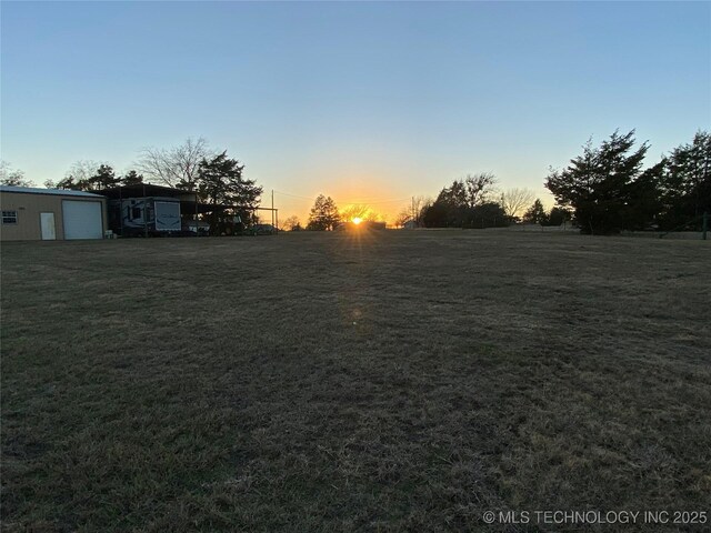 591 Peanut Trl, Hendrix, OK 74741 - view of green lawn with a garage