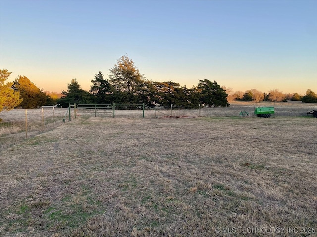 yard at dusk with a rural view