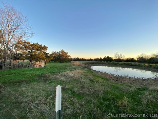 yard at dusk with a water view