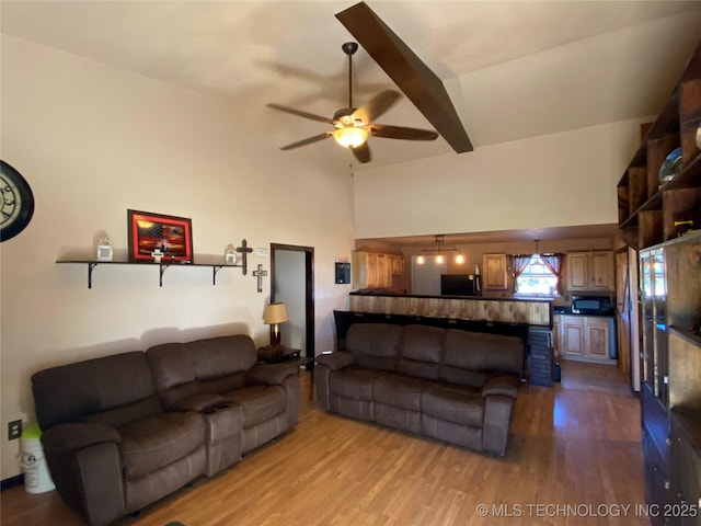 living room featuring light wood-type flooring and ceiling fan