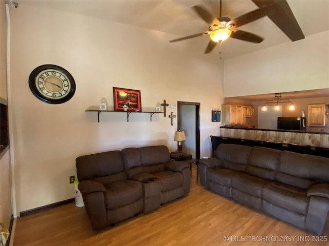 living room featuring ceiling fan and hardwood / wood-style floors