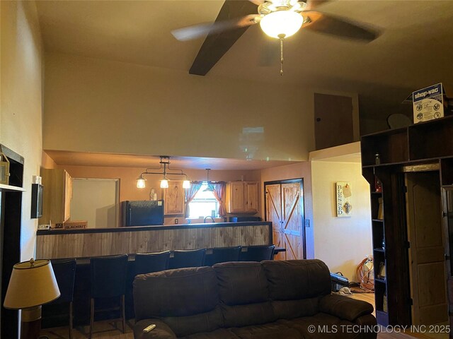 living room featuring ceiling fan and sink