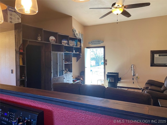 living room featuring a wall unit AC and ceiling fan