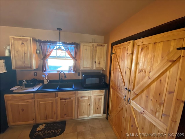 kitchen with pendant lighting, light tile patterned floors, and sink