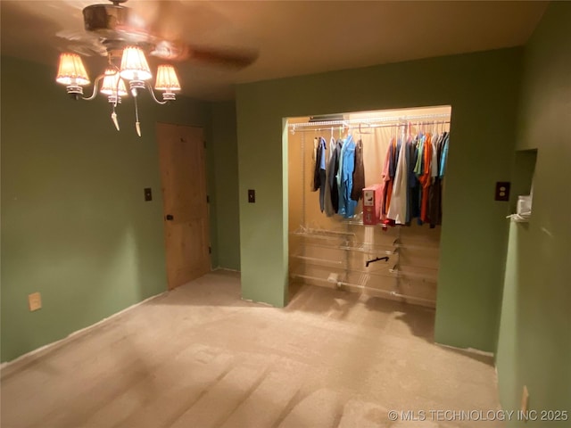 unfurnished bedroom with light colored carpet and a closet