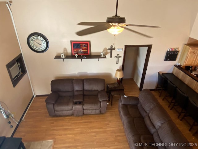 living room with light hardwood / wood-style floors and ceiling fan