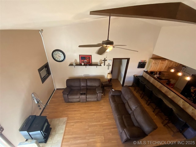 living room with vaulted ceiling with beams, light hardwood / wood-style floors, and ceiling fan