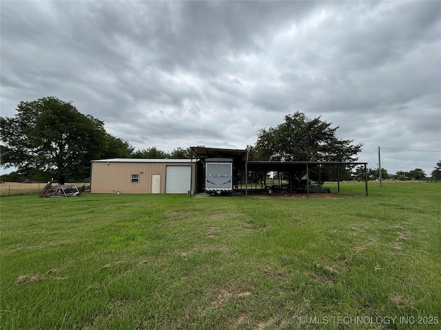 591 Peanut Trl, Hendrix, OK 74741 - view of green lawn featuring a garage and an outbuilding