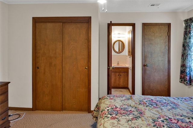 bedroom featuring ensuite bathroom and sink