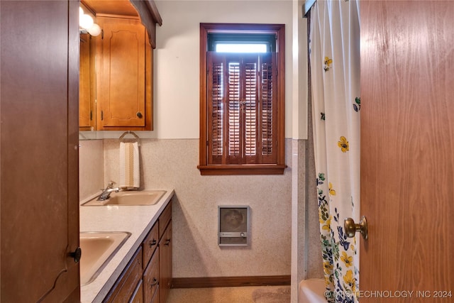 bathroom featuring shower / bath combination with curtain and vanity