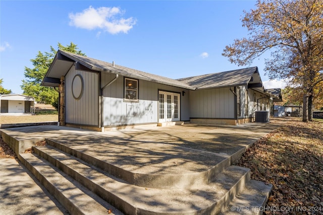 ranch-style home with central air condition unit and french doors