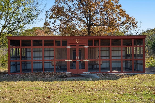 back of property featuring a yard