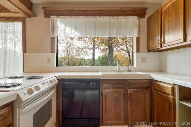 kitchen with tile countertops, white electric range oven, decorative backsplash, and black dishwasher