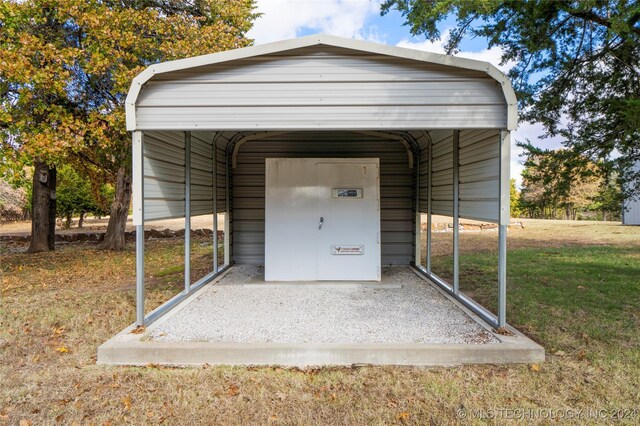 view of outdoor structure with a yard and a carport