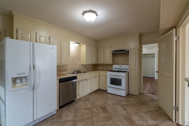 kitchen with tasteful backsplash, white appliances, sink, white cabinetry, and range hood