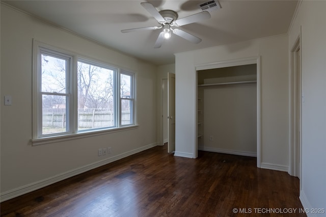 unfurnished bedroom featuring ceiling fan, dark wood-type flooring, and a closet