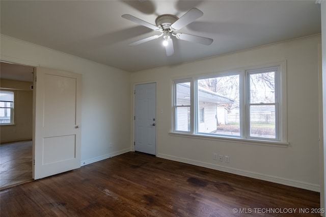 interior space with ceiling fan, dark hardwood / wood-style flooring, and ornamental molding