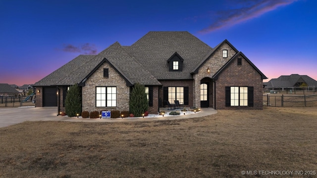 french country style house featuring a yard