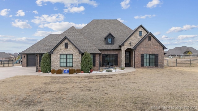 french provincial home featuring a garage