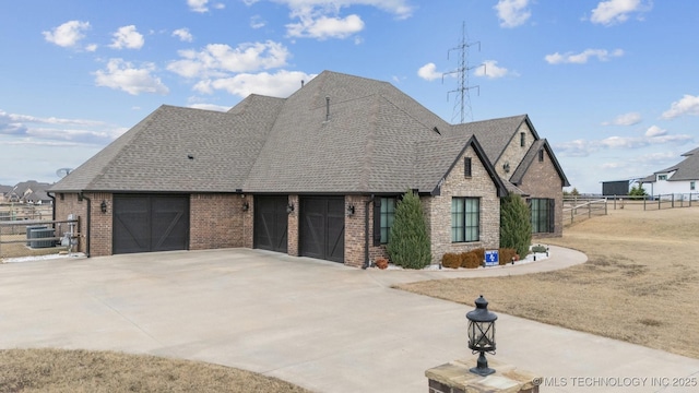 view of front of home with central AC and a garage