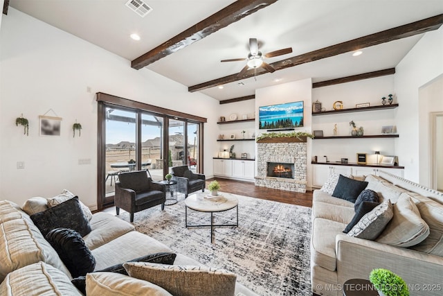 living room featuring a fireplace, wood-type flooring, ceiling fan, and beam ceiling