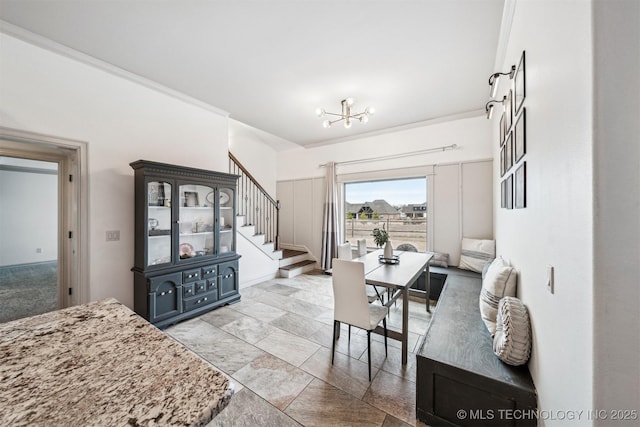 living room with crown molding and a notable chandelier