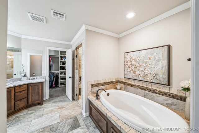 bathroom with plus walk in shower, vanity, and ornamental molding