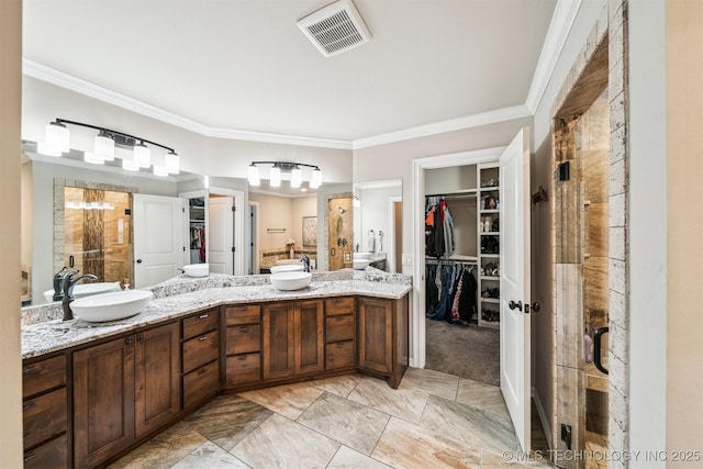 bathroom with vanity, ornamental molding, and a shower with door