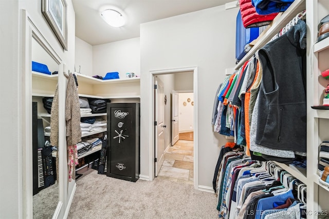 walk in closet featuring light carpet