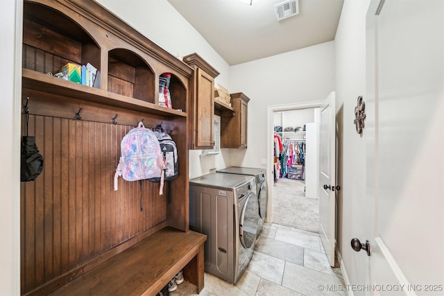 mudroom featuring light colored carpet and washer and dryer