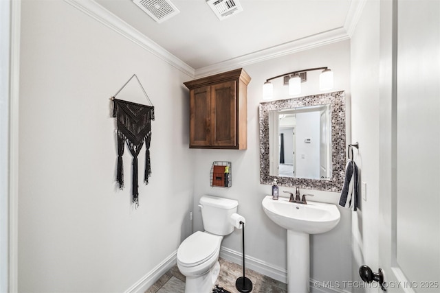 bathroom featuring toilet and ornamental molding