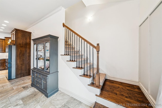 stairs featuring crown molding