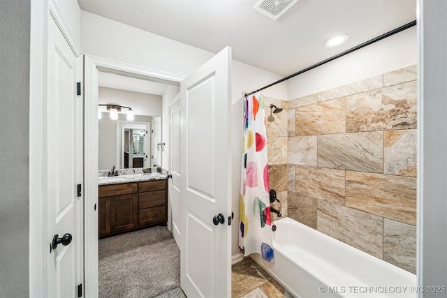 bathroom with shower / bath combo and vanity