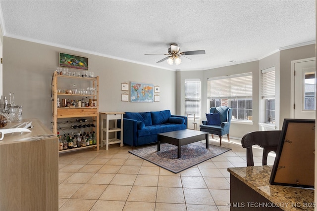 tiled living room with ceiling fan and ornamental molding