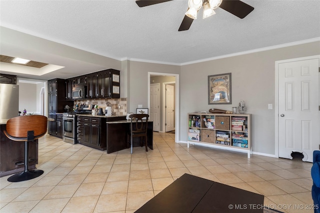 kitchen with light tile patterned floors, dark brown cabinetry, stainless steel appliances, and ornamental molding