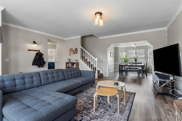 living room with dark hardwood / wood-style flooring and crown molding