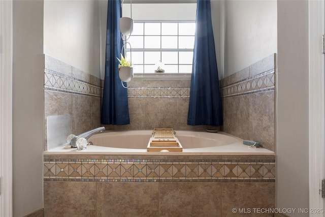 bathroom featuring tile walls and tiled tub