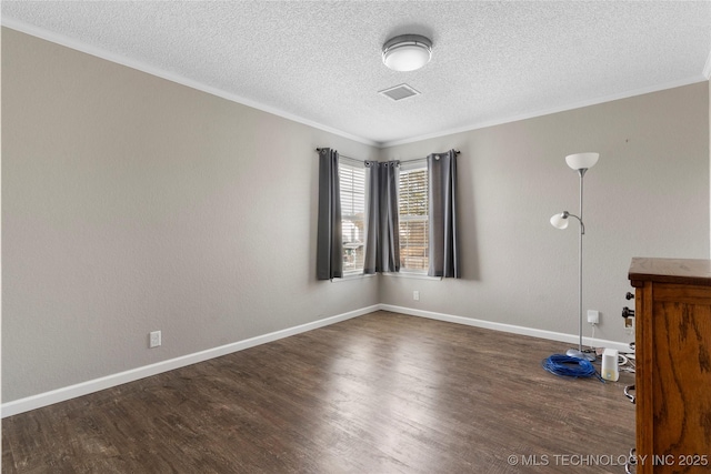 unfurnished room featuring a textured ceiling, dark wood-type flooring, and ornamental molding