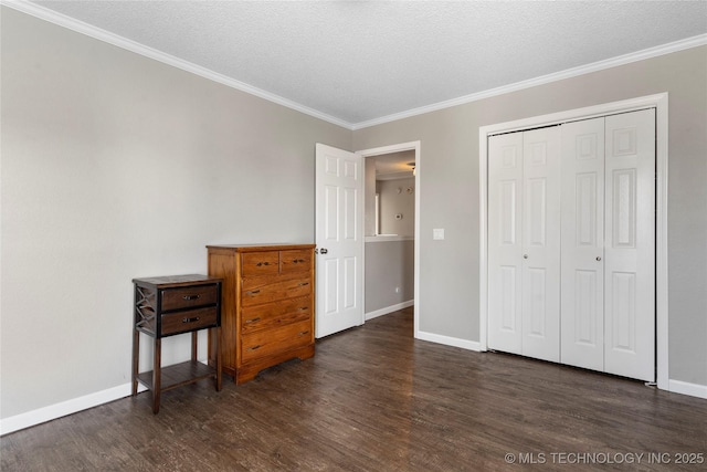 bedroom featuring dark hardwood / wood-style flooring, crown molding, a closet, and a textured ceiling