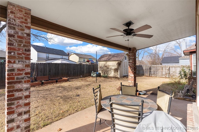 view of patio with a shed and ceiling fan