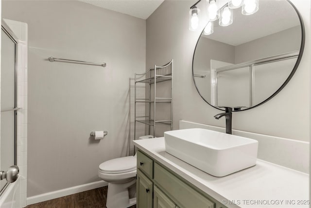 full bathroom with enclosed tub / shower combo, vanity, toilet, and hardwood / wood-style floors