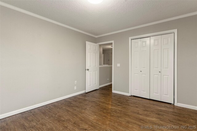 unfurnished bedroom featuring dark hardwood / wood-style flooring, crown molding, a closet, and a textured ceiling