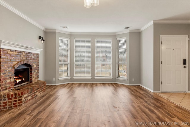 unfurnished living room with ornamental molding, hardwood / wood-style floors, and a fireplace