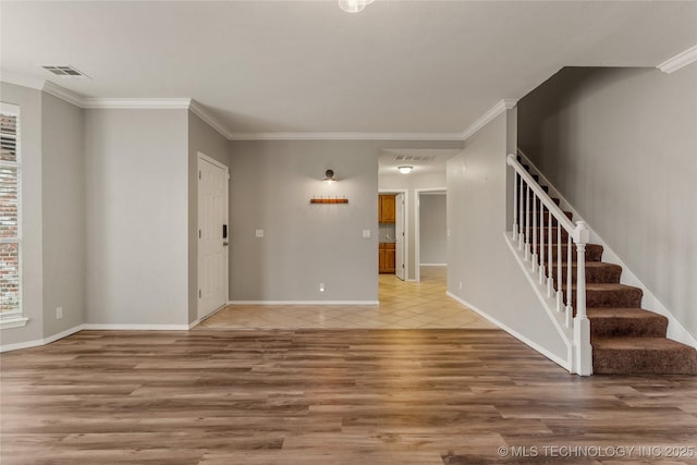 unfurnished living room with hardwood / wood-style flooring and ornamental molding