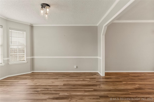 spare room with crown molding, hardwood / wood-style floors, and a textured ceiling