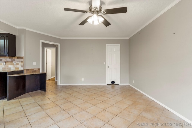 kitchen featuring light tile patterned flooring, decorative backsplash, ornamental molding, ceiling fan, and a textured ceiling